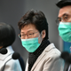 Hong Kong’s Chief Executive Carrie Lam (C) takes part in a press conference while wearing a facemask in Hong Kong on January 28, 2020.